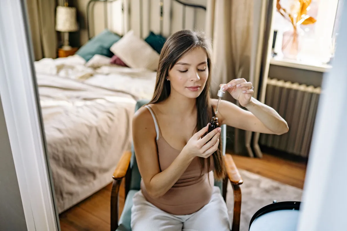 pregnant woman holding bottle of Tylenol