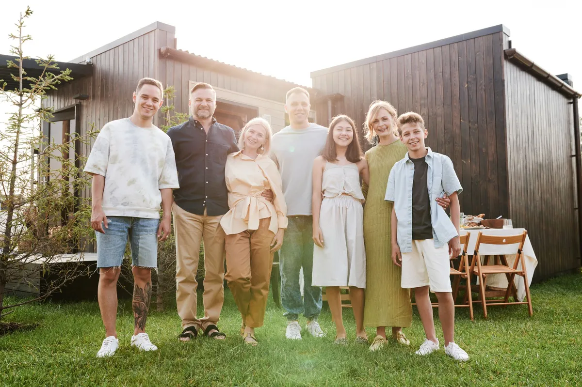 happy family in front of home