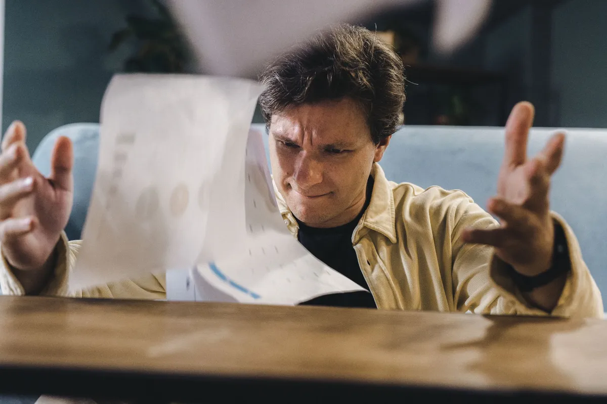 stressed homeowner with paperwork