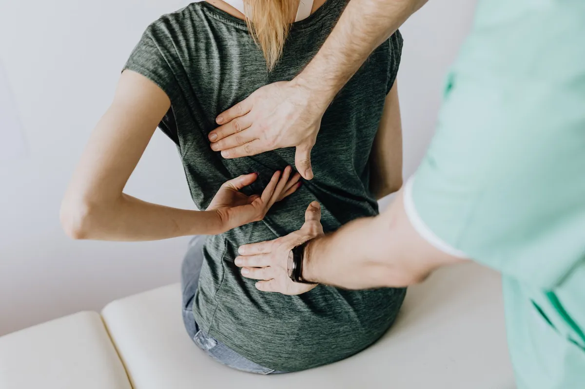 chiropractor examining patient