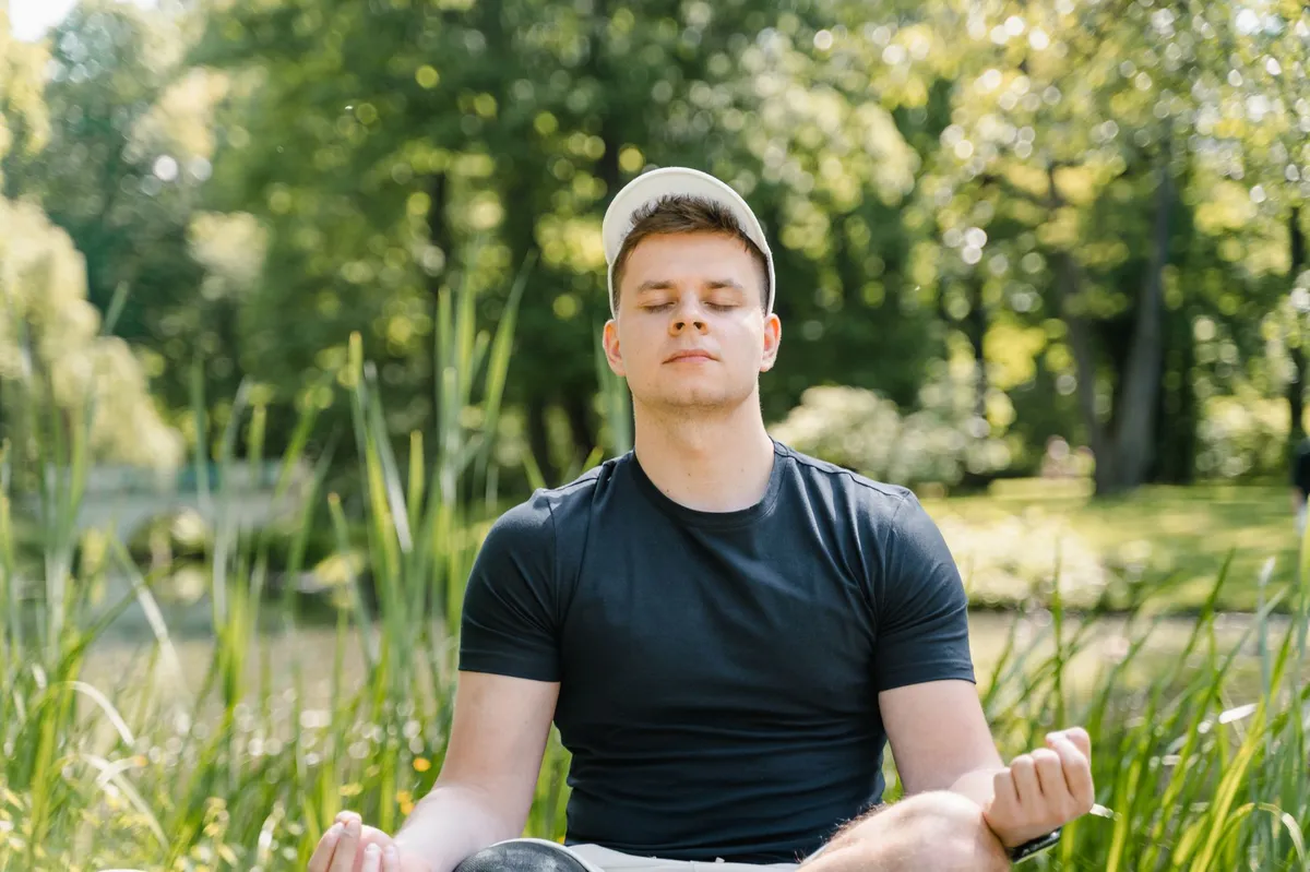 person meditating outdoors