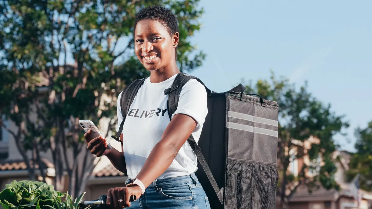 happy delivery worker with groceries