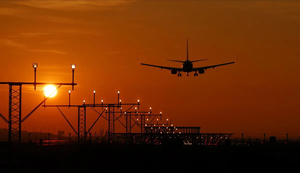 airplane taking off at sunset