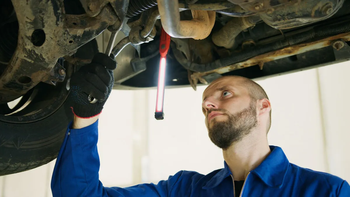 mechanic inspecting vehicle