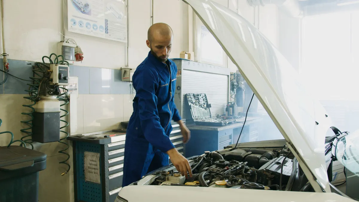 mechanic inspecting car engine
