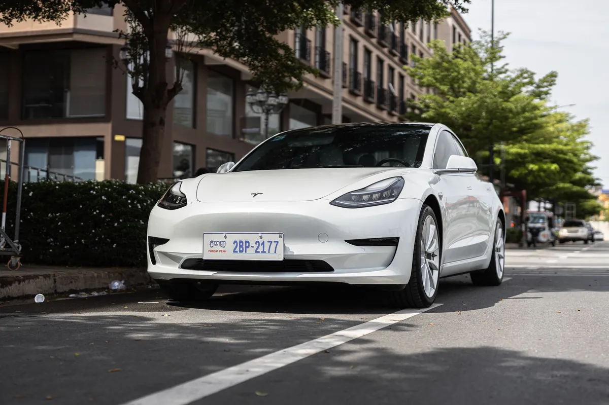Tesla Model 3 driving on road