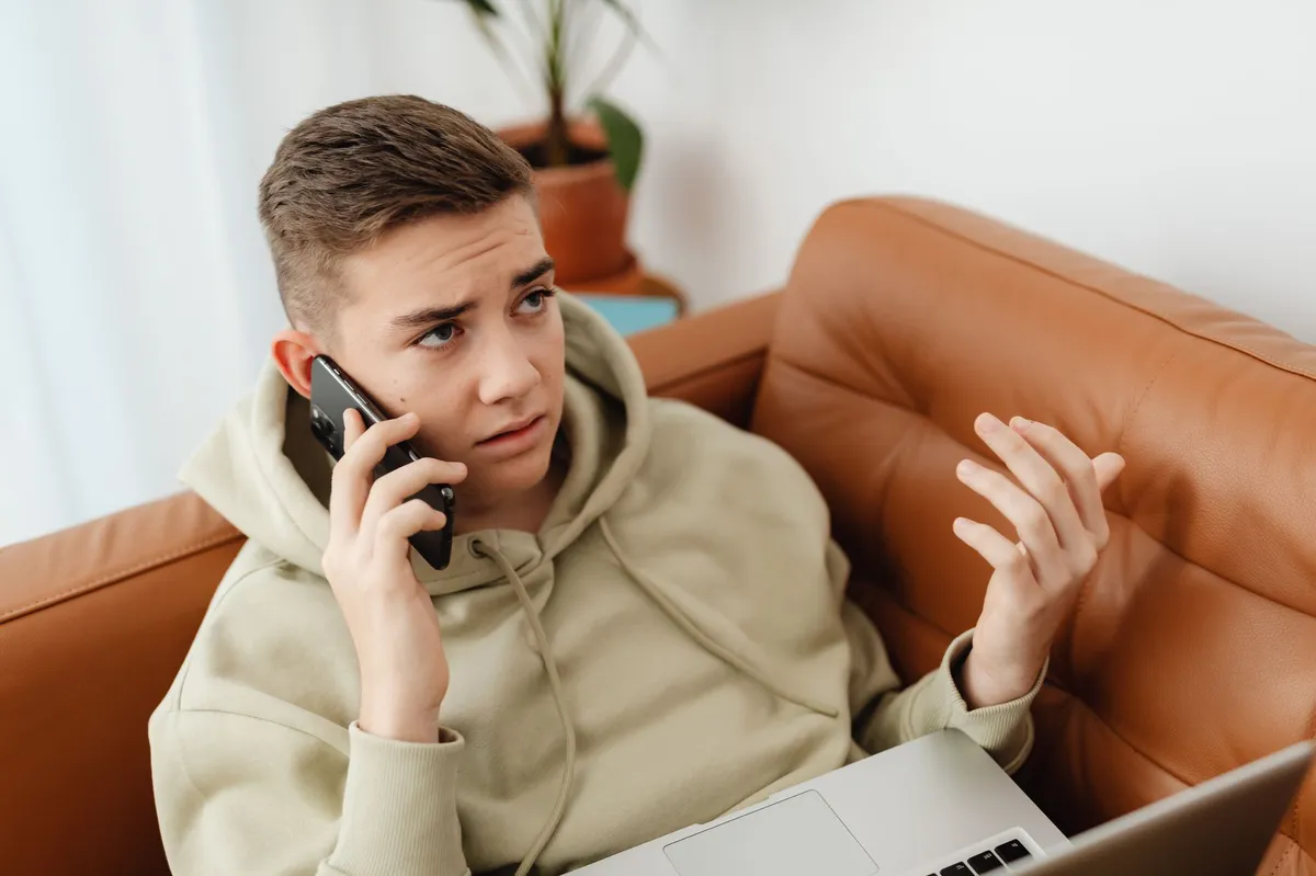 concerned teenager looking at phone