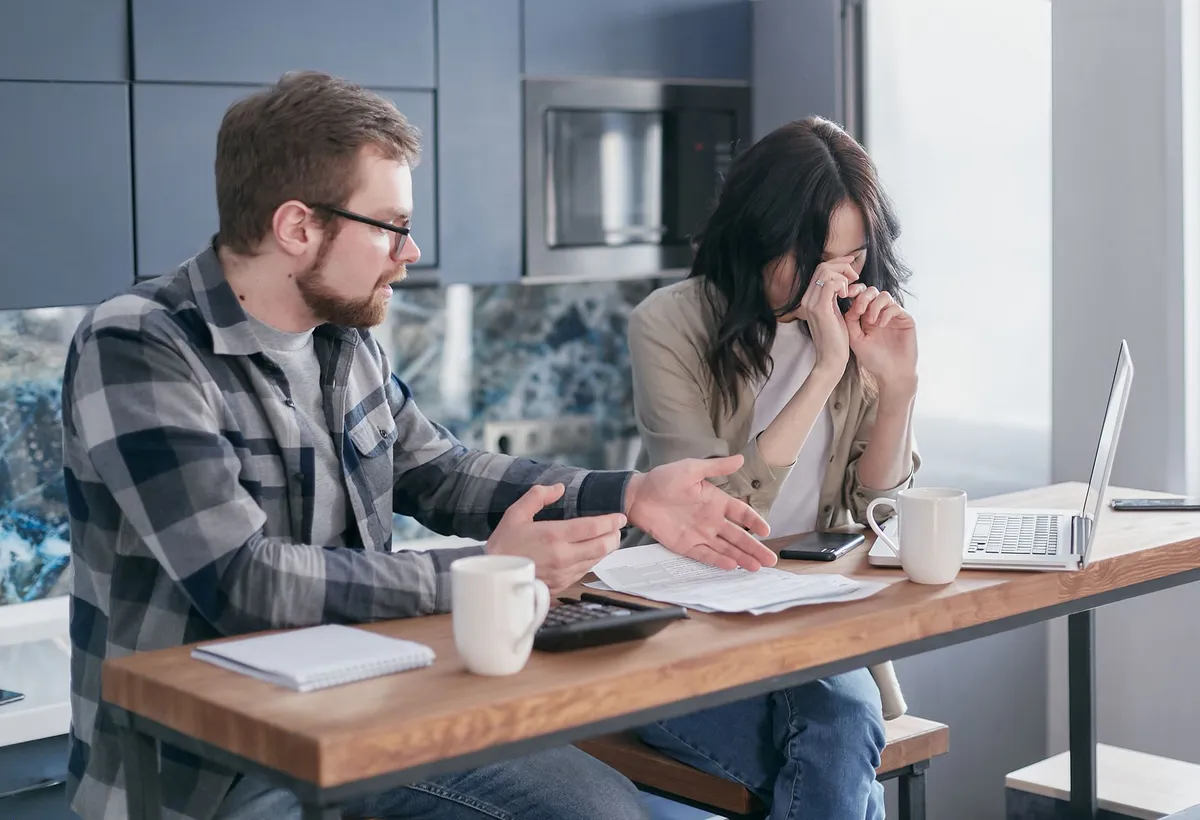 worried homeowner looking at bills