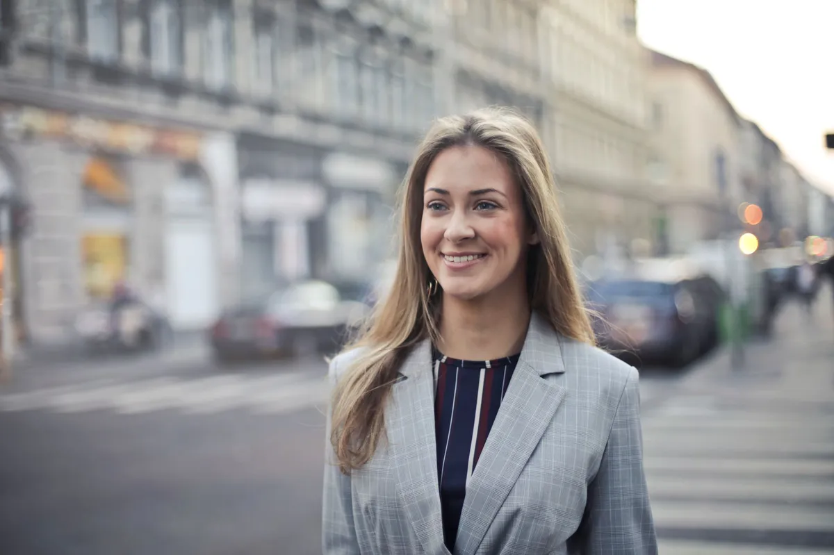 woman in business attire smiling