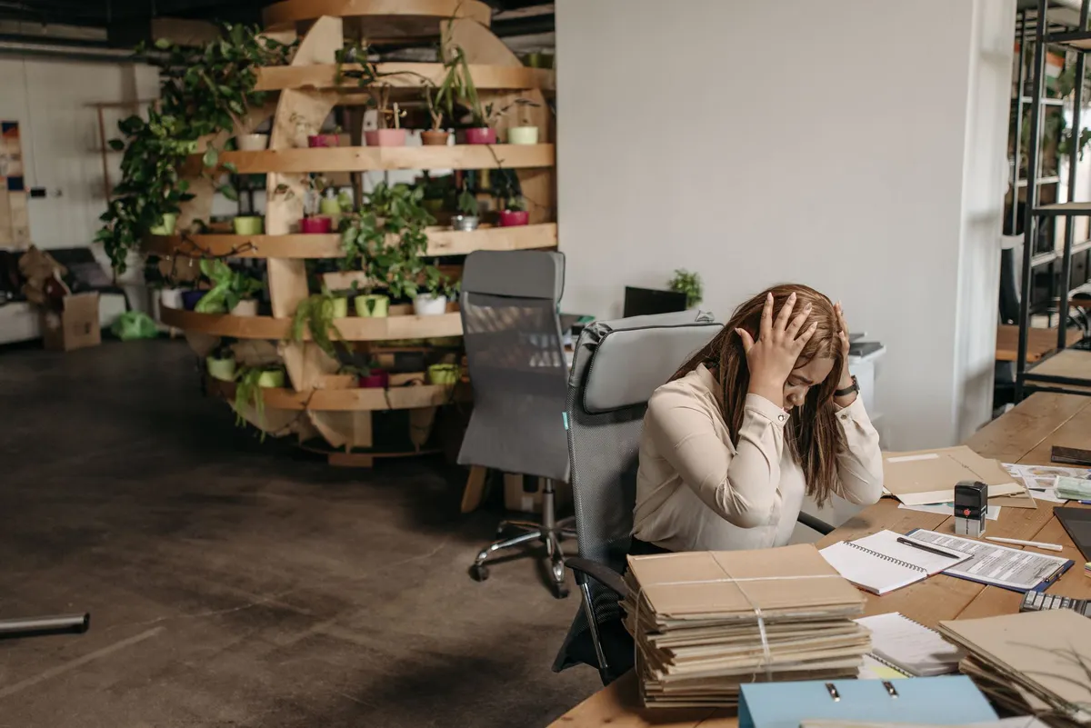 frustrated employee with paperwork
