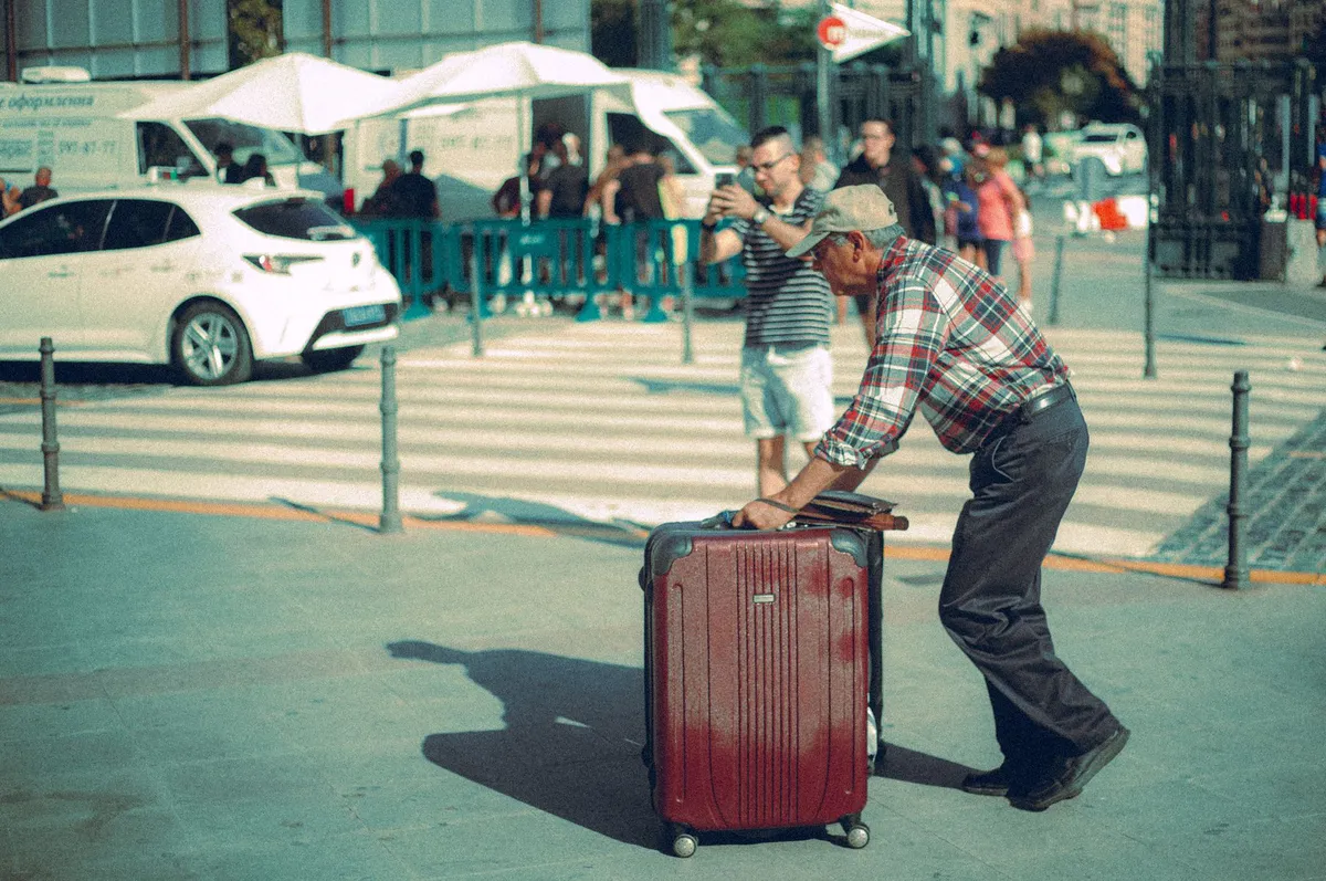 elderly traveler with suitcase