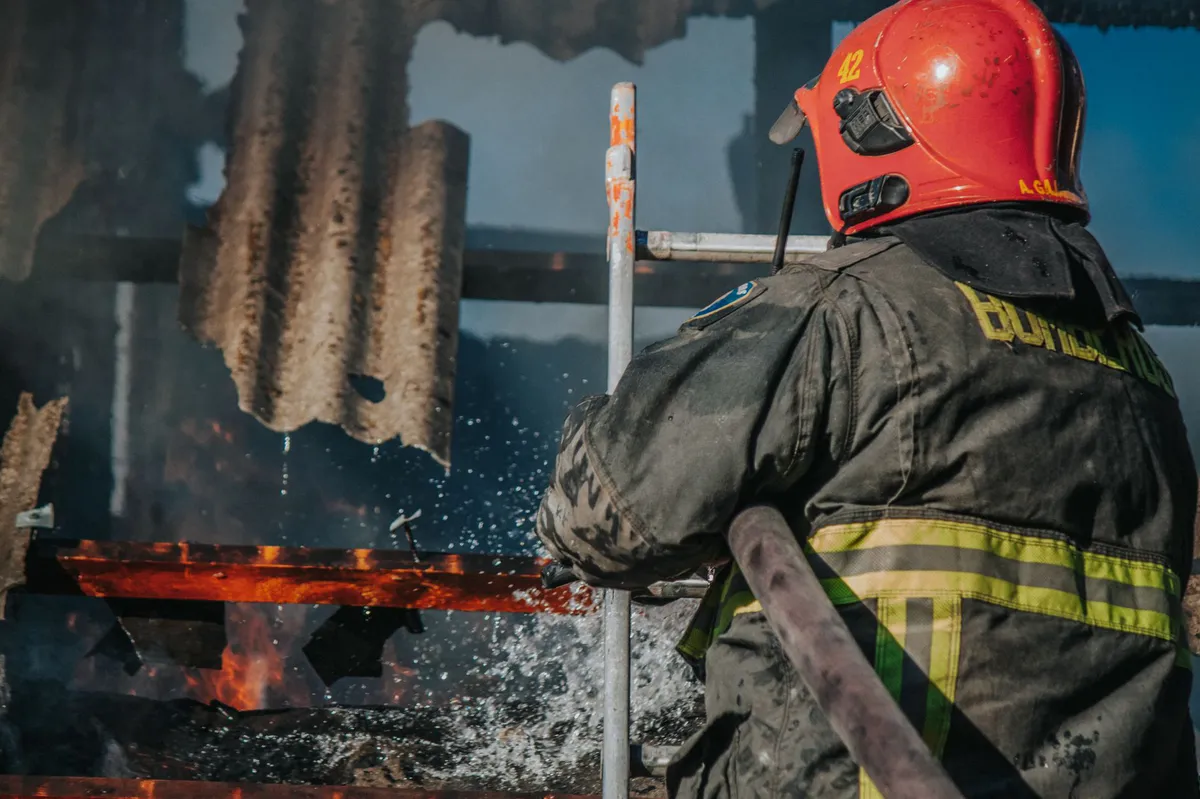 firefighter battling blaze