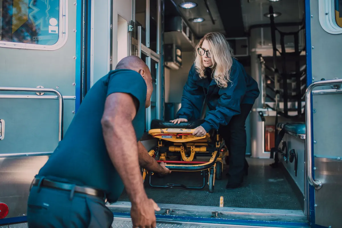healthcare worker lifting patient